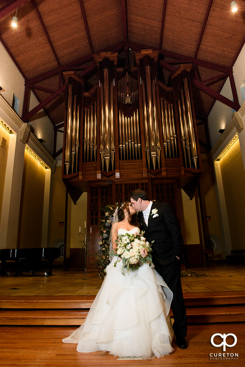 Couple kissing after their wedding at Daniel Chapel.