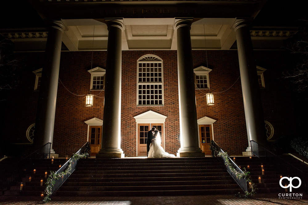 Gorgeous back with photo of a bride and groom in front of Daniel chapel on the Furman university campus in Greenville South Carolina after their wedding.