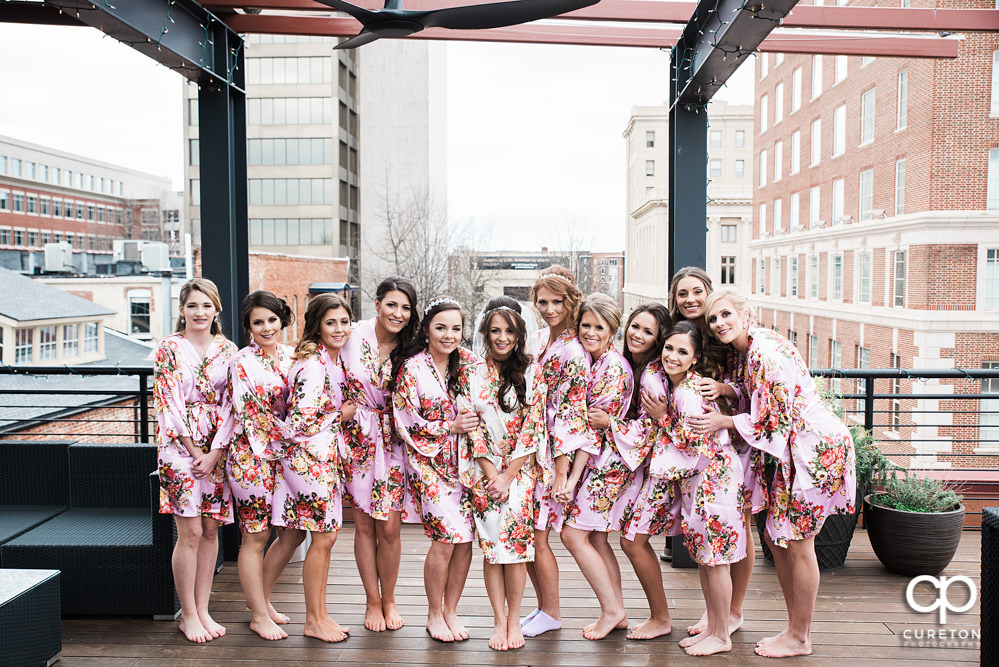 Bride and bridesmaids standing on the roof of Soby's loft in downtown Greenville.