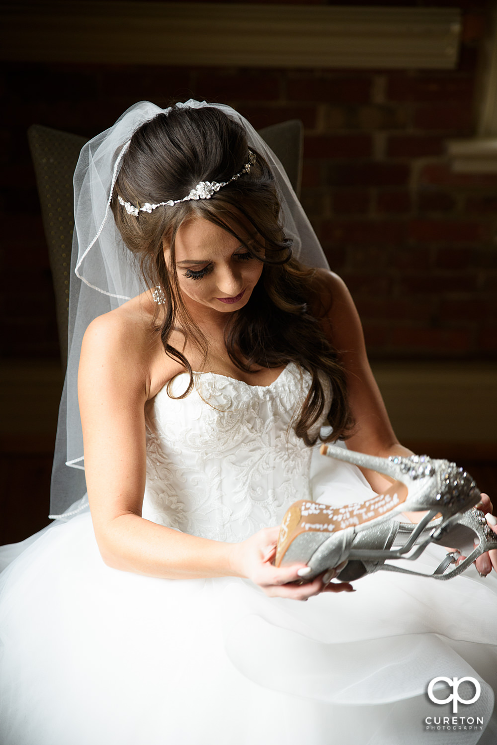 Bride reading a note left on her shoes.