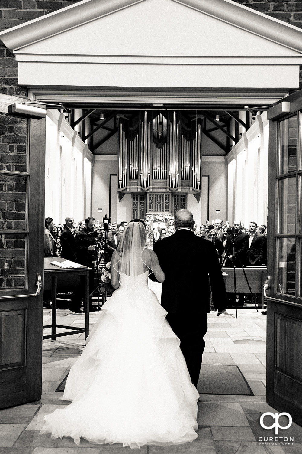 Bride and her father walking down the aisle.