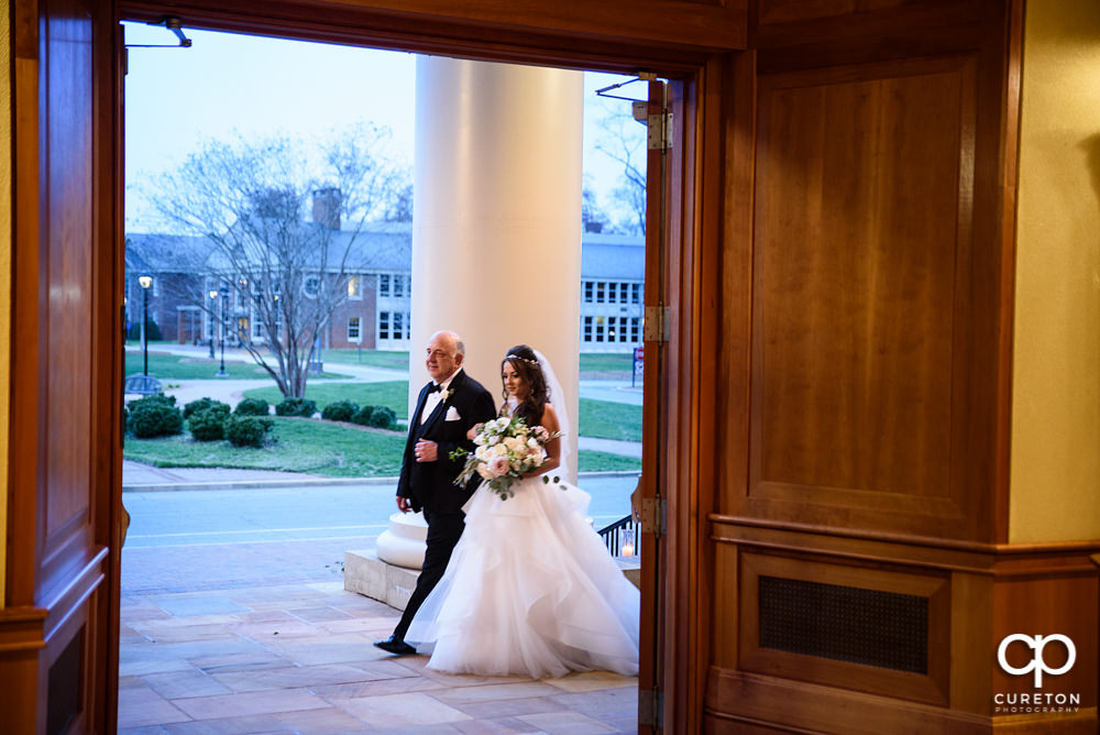 Bride and her father walking into the chapel.