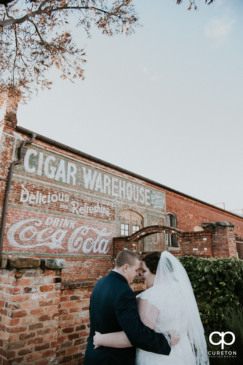 Bride and groom outside the Old Cigar Warehouse before their downtown Greenville wedding.
