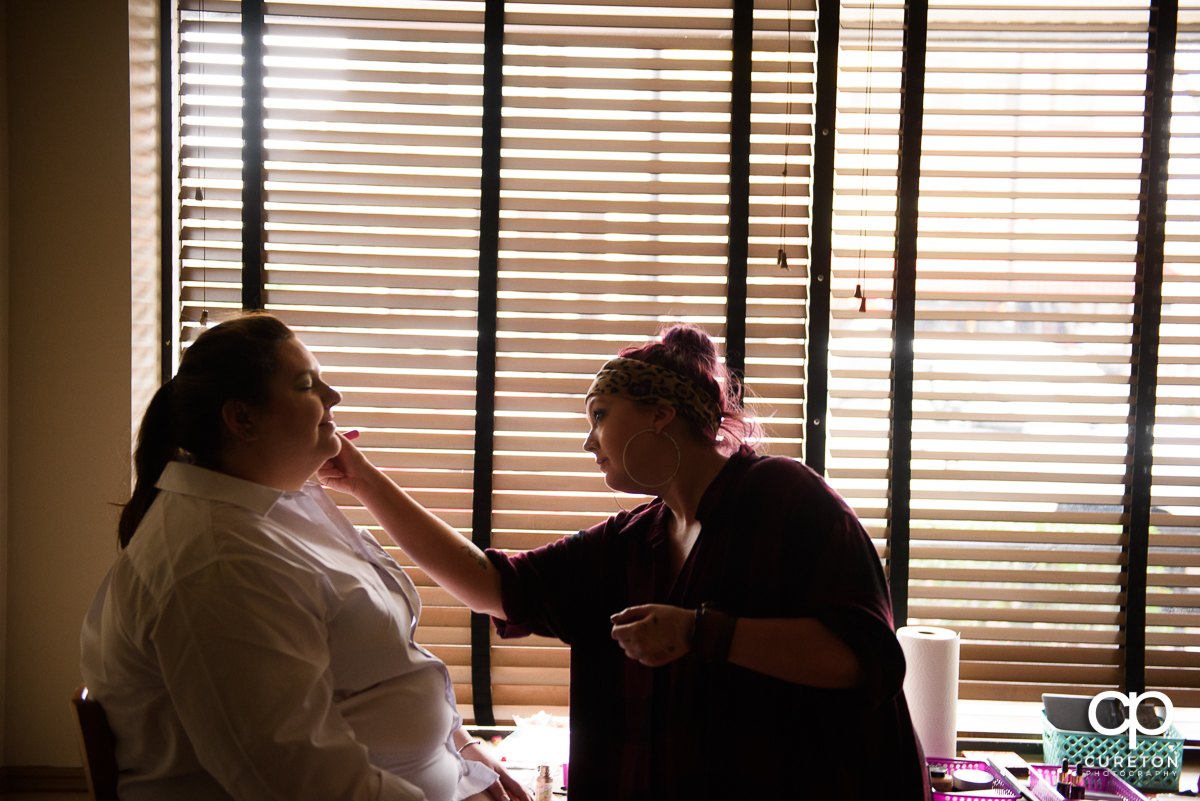 Bride getting her makeup up before her wedding at The Westin Poinsett hotel.