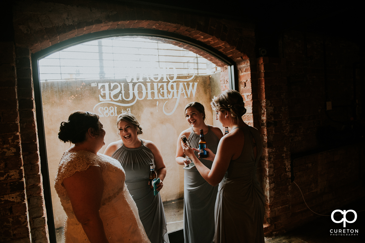Bride and bridesmaids having a drink before the wedding at the Old Cigar Warehouse.