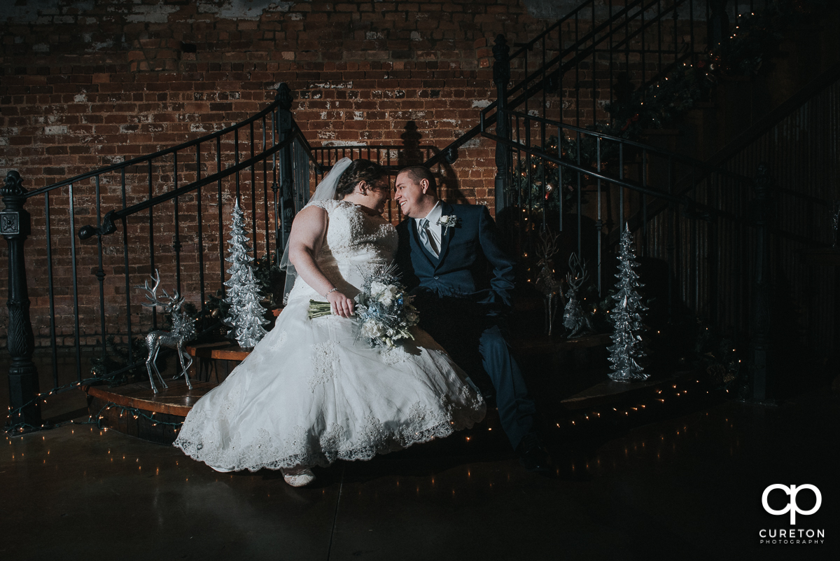 Bride and groom on the staircase at Old Cigar Warehouse.