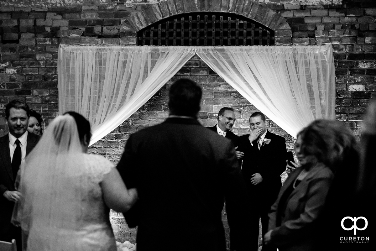 Groom crying when he sees his bride walking down the aisle for the first time.