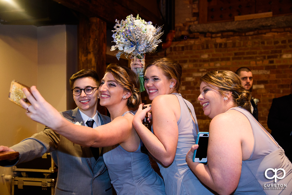 Bridesmaids taking a selfie.