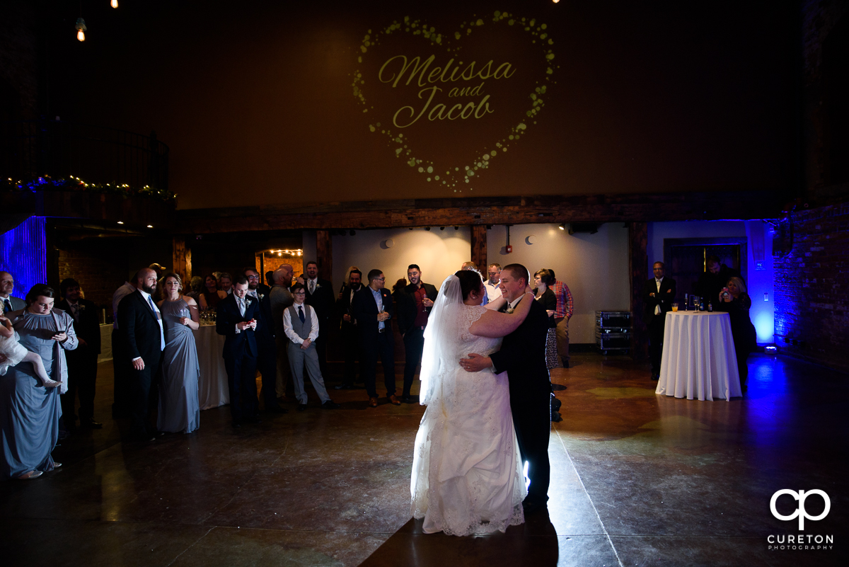 Bride and groom having a first dance at The Old Cigar Warehouse.