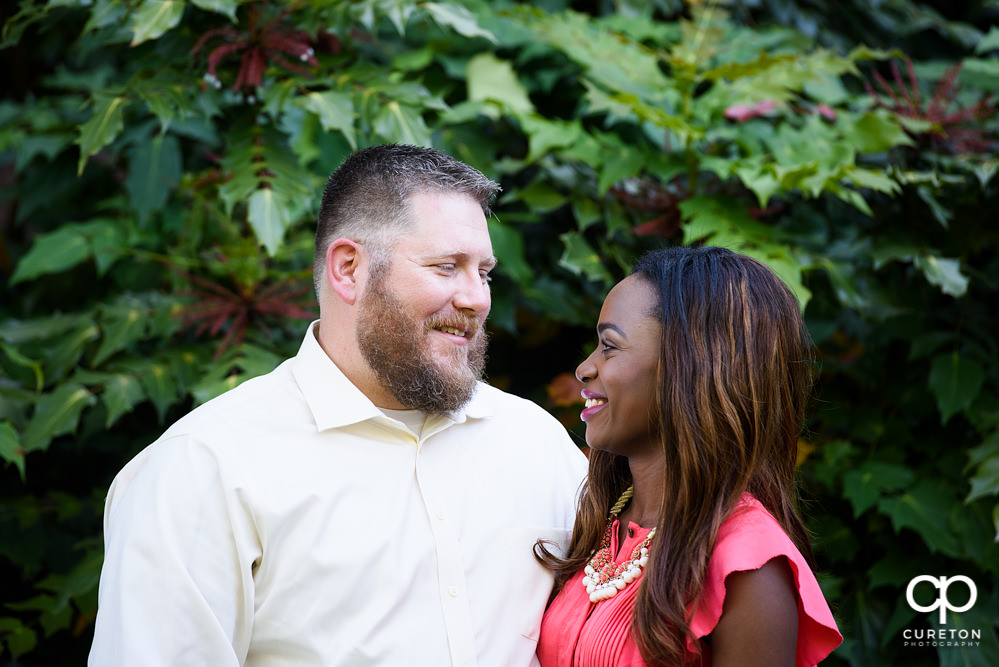 Engaged couple smiling.