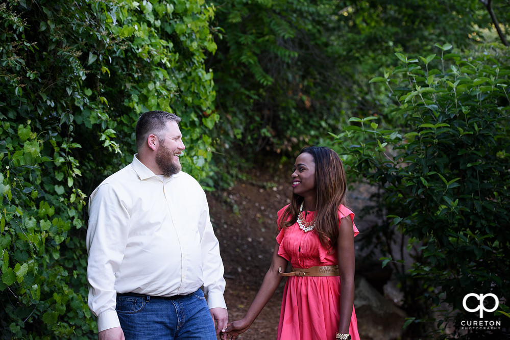 Couple strolling through the trails during their downtown Greenville park engagement session.