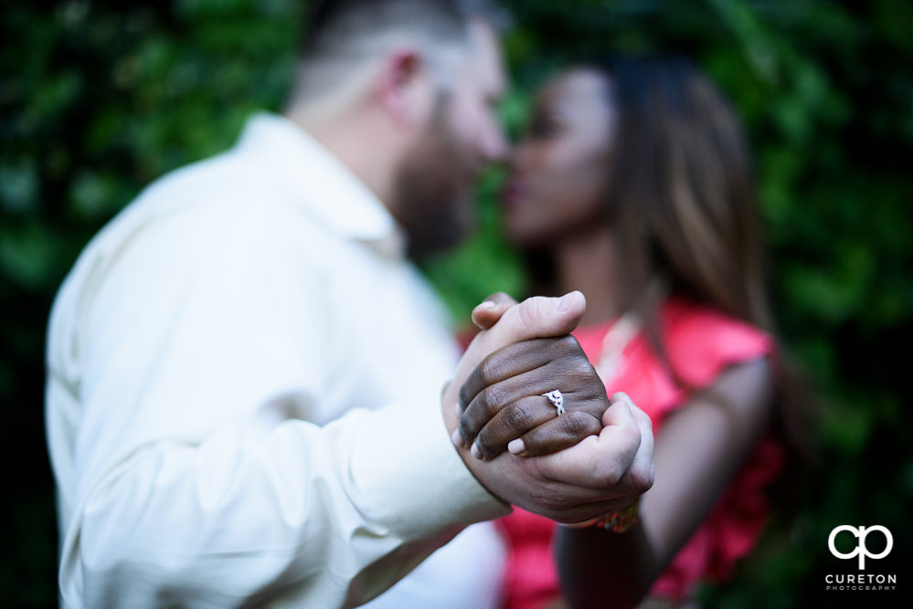 Bride and groom showing off the ring.