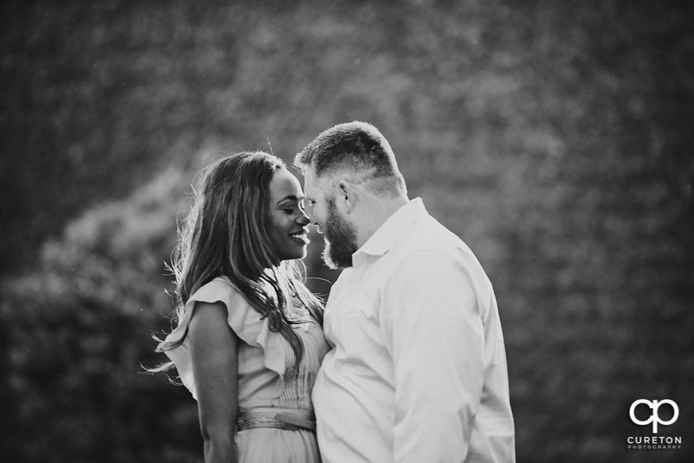 Groom and bride snuggling.