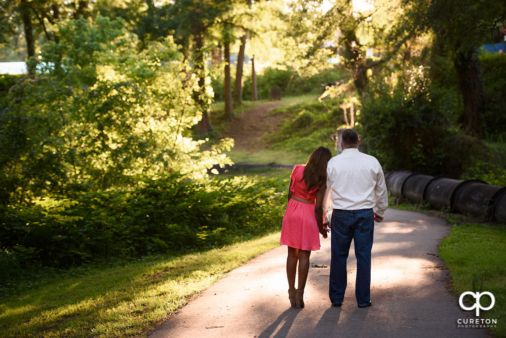 Groom and Bride walking down the path.