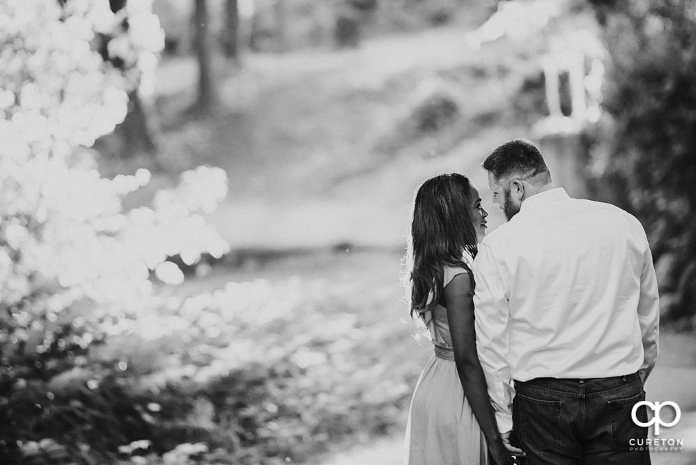 Bride and Groom walking in the park.