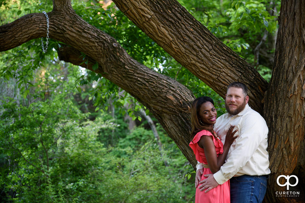 Bride and groom near an oak tree