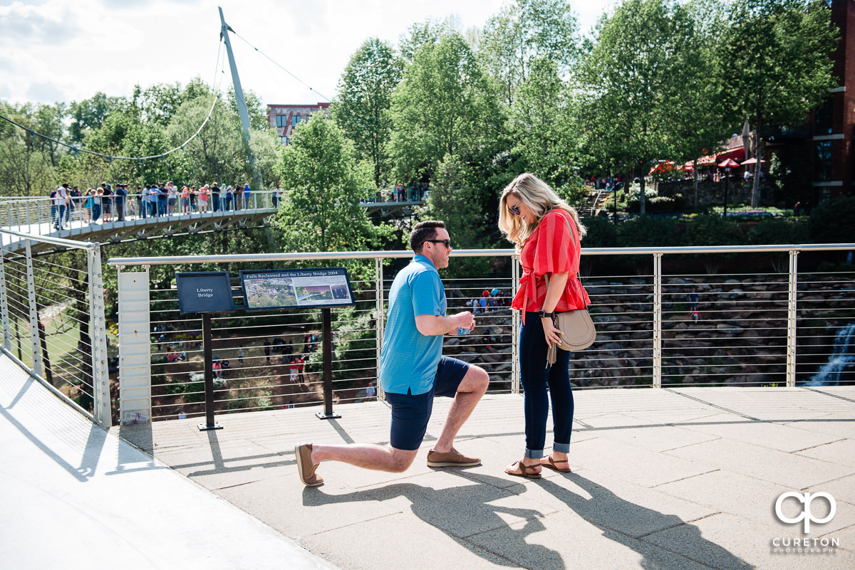 Man gets on one knee and asks for his girlfriend's hand in marriage during a surprise proposal in downtown Greenville ,SC.