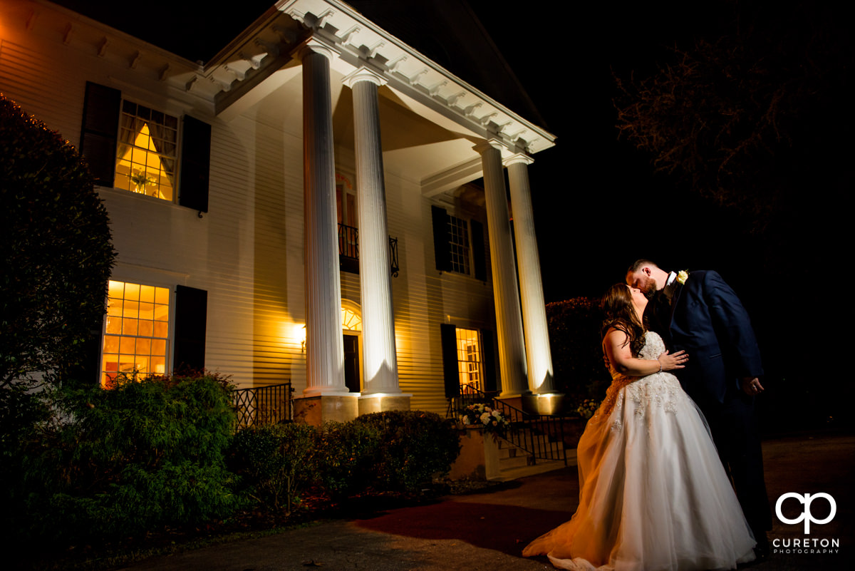 Epic bride and groom night photo in front of the plantation style home during their Duncan Estate wedding in Spartanburg,SC.