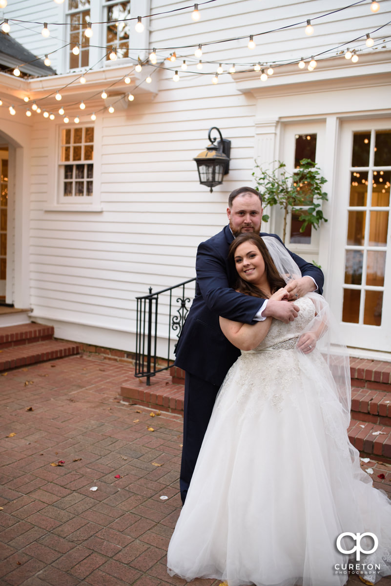 Groom holding his bride on the patio at their Duncan Estate wedding in Spartanburg,SC.