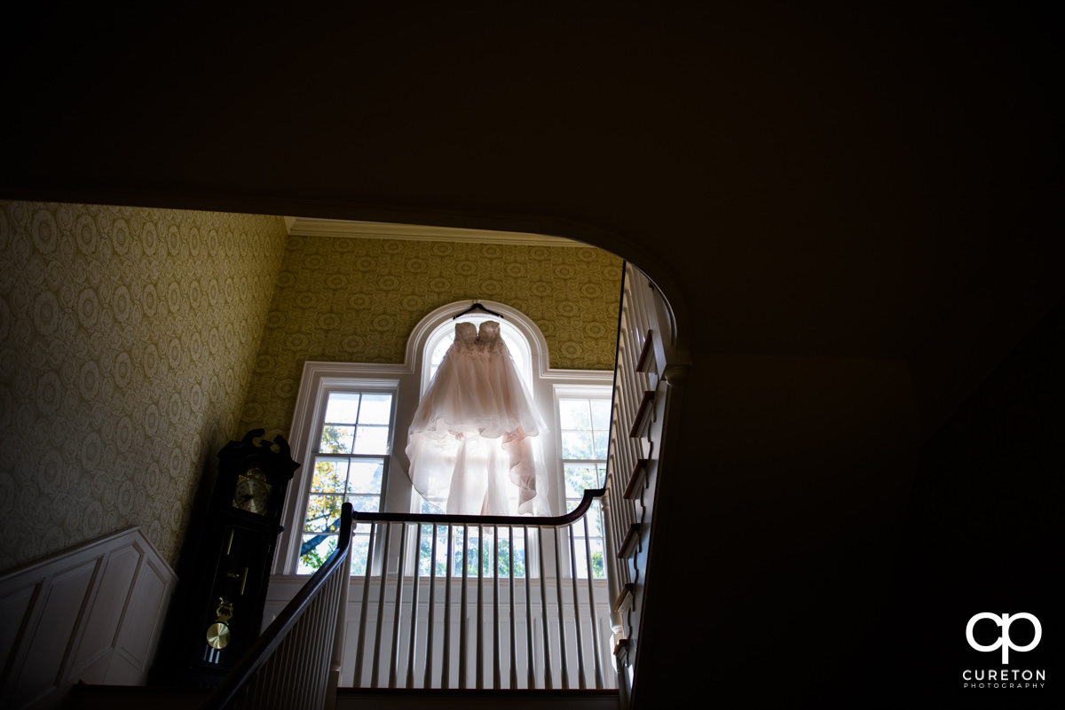 Bride's dress hanging upstairs in a window at the Duncan Estate in Spartanburg,SC.