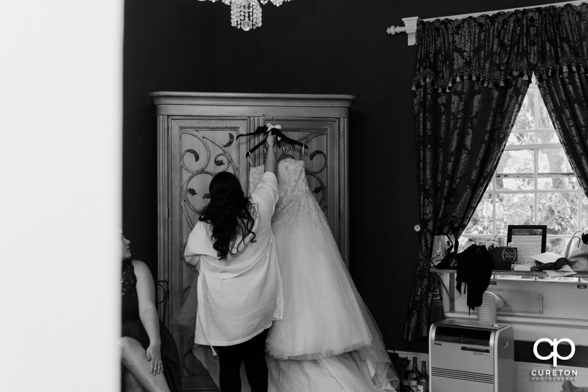 Bride hanging her dress.
