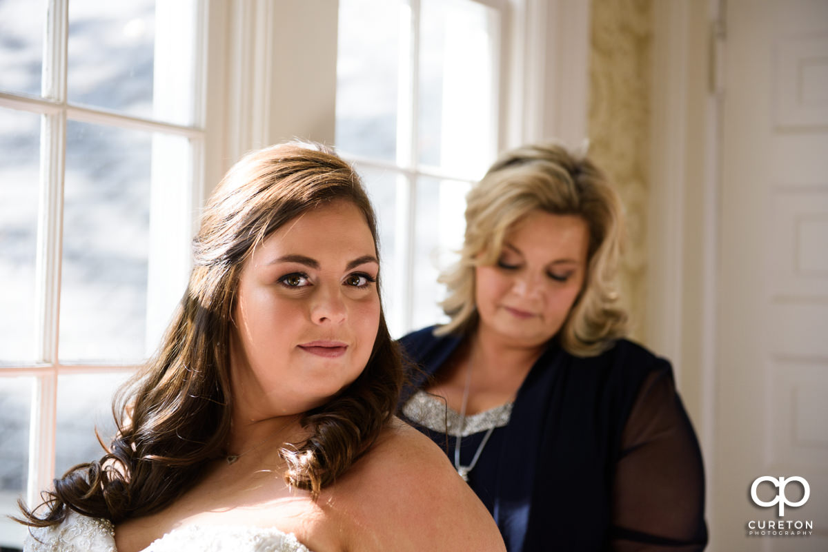 Bride getting ready with her mother.