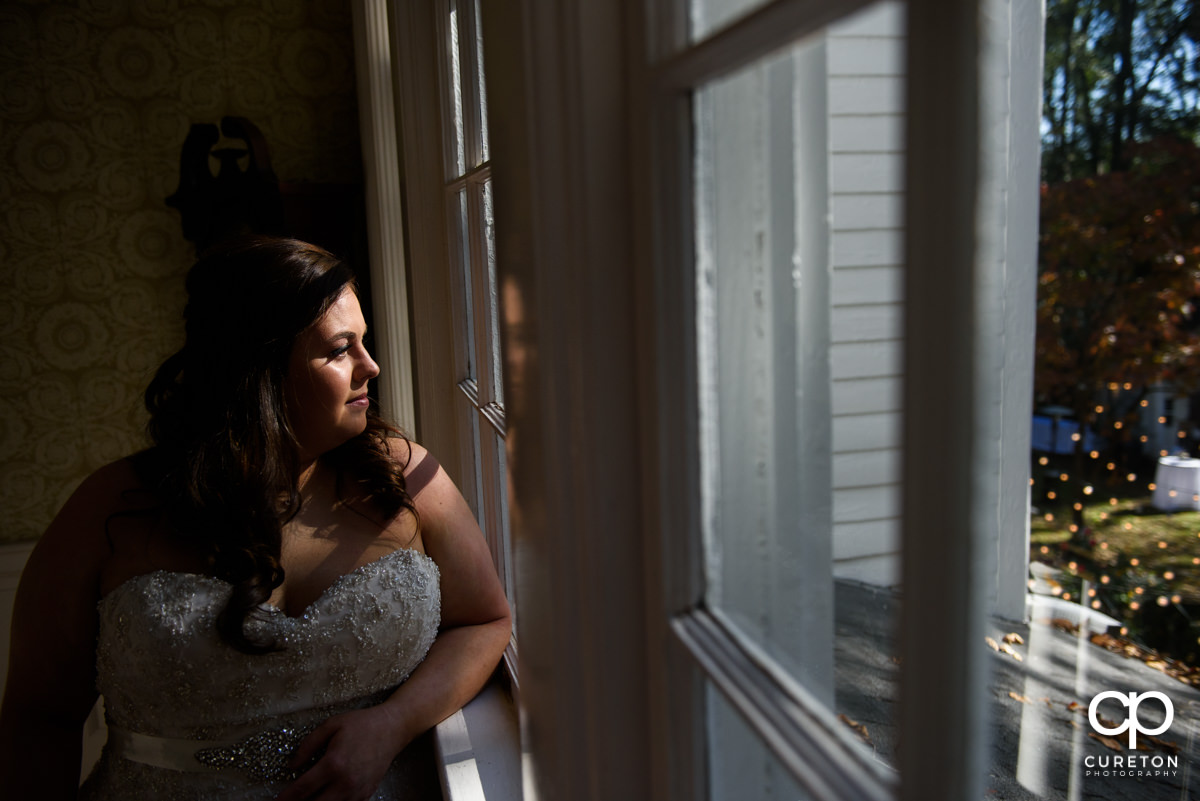 Bride looking out the window.