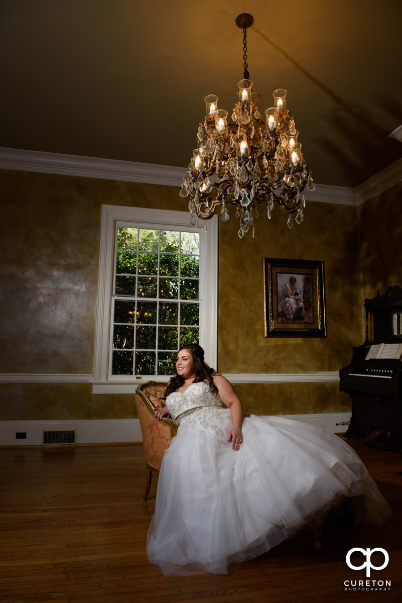 Bride sitting in on a fainting couch.
