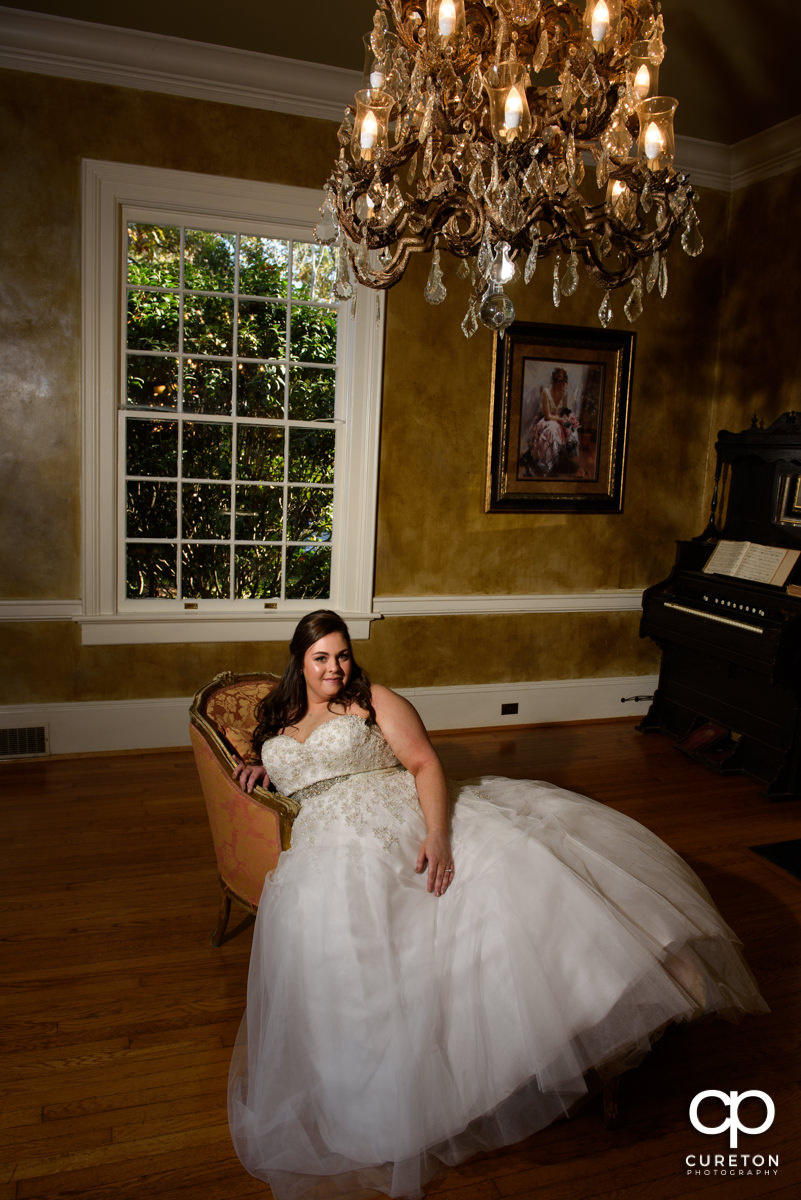 Bride sitting in on a fainting couch before her wedding at the Duncan Estate in Spartanburg,SC.