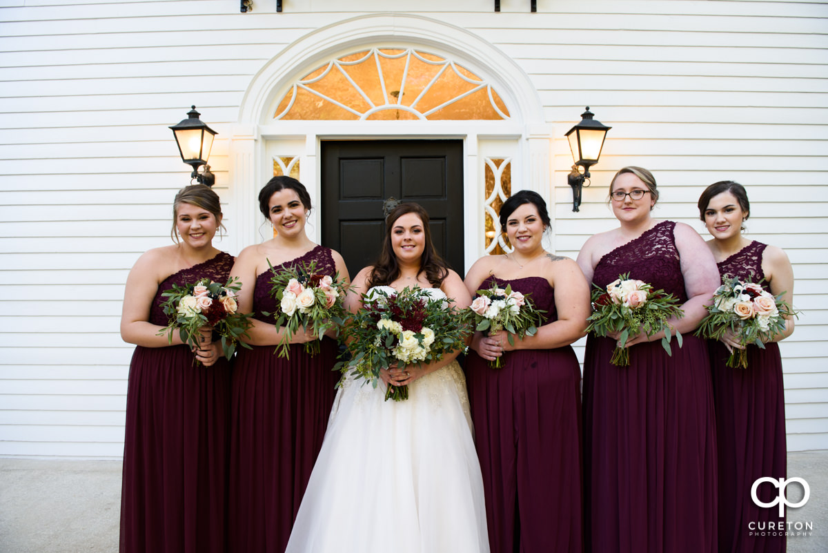Bride and the bridesmaids standing in front of the house before the Duncan Estate wedding.