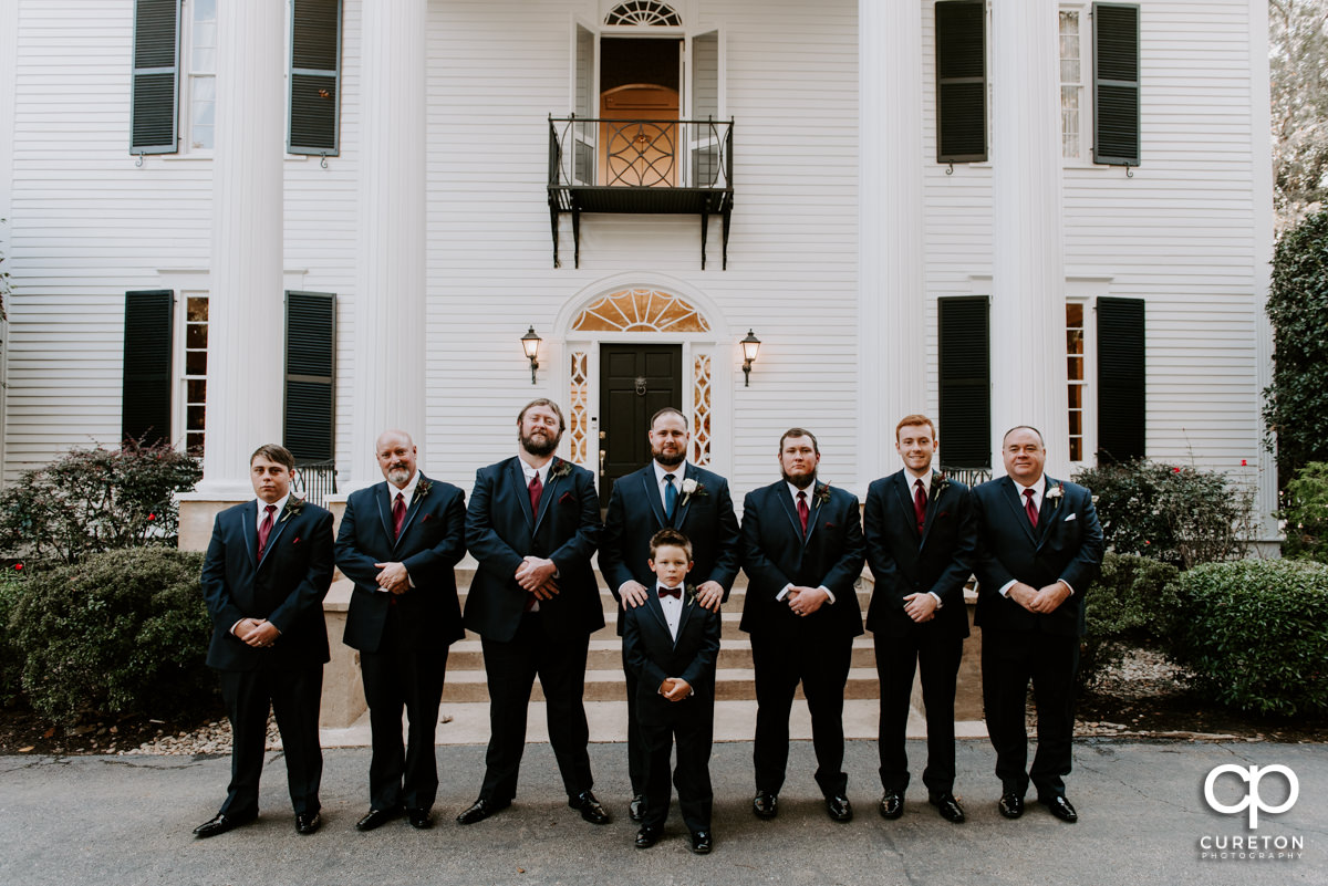 Groom and groomsmen standing in front of the house before the Duncan Estate wedding.