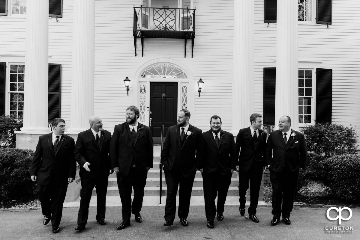 Groom and groomsmen walking in front of the house before the Duncan Estate wedding.