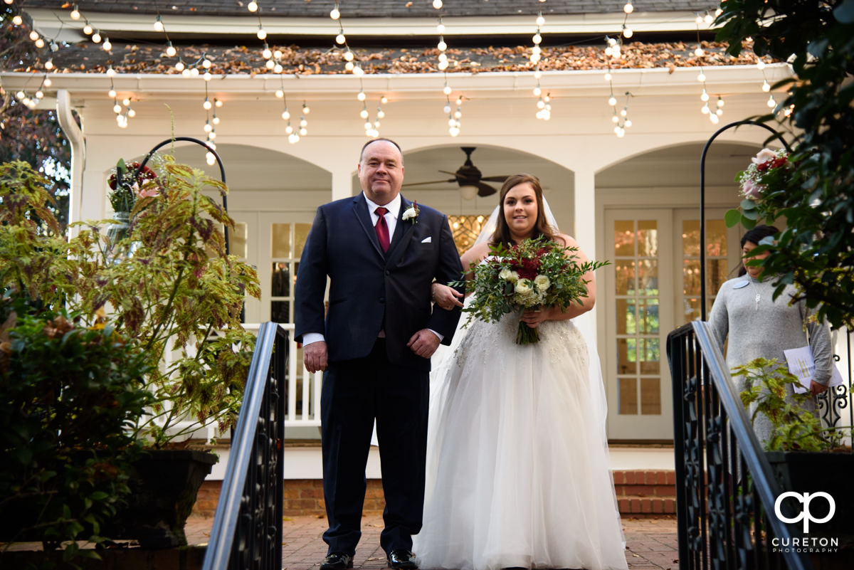 Bride and her father making an entrance into the wedding ceremony.