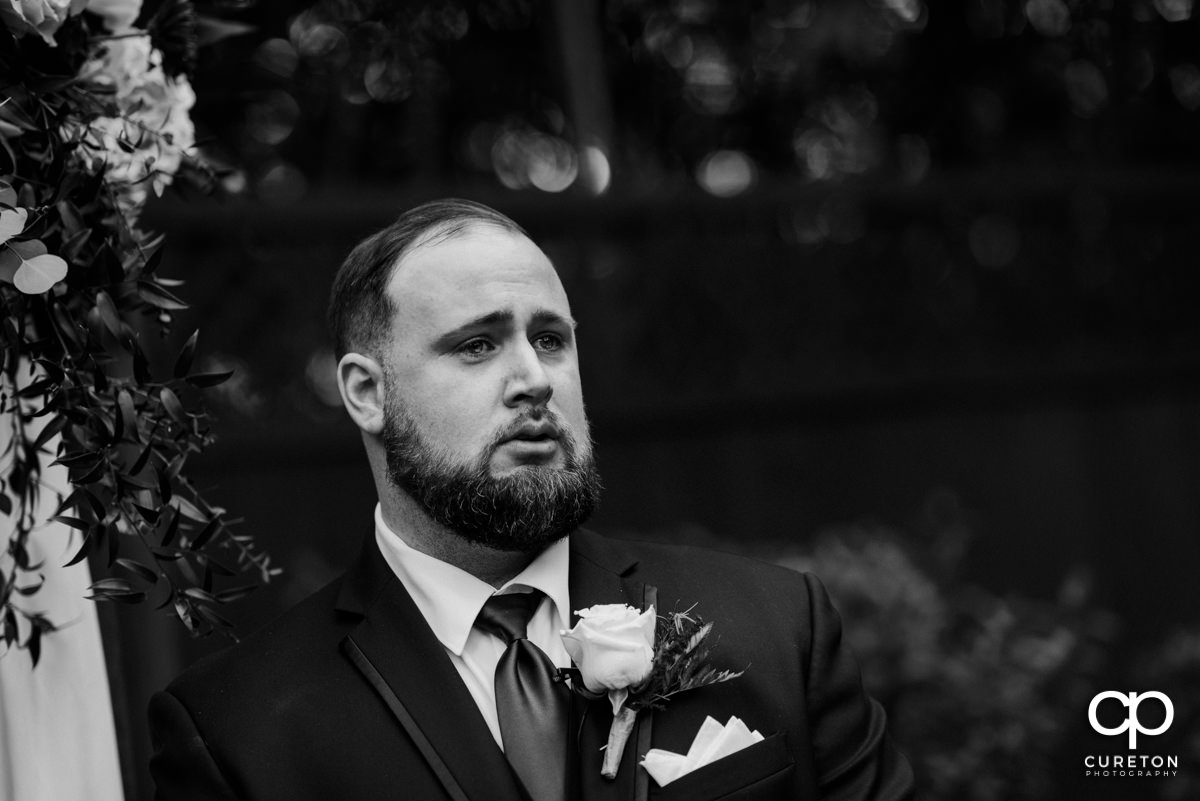 Groom tearing up as he sees his bride walking down the aisle at the Duncan Estate wedding in Spartanburg,SC.