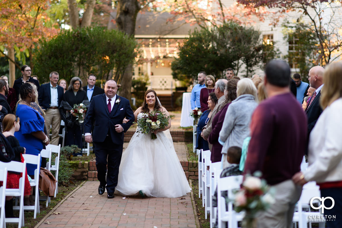 Bride walking down the aisle with her father at Duncan Estate.