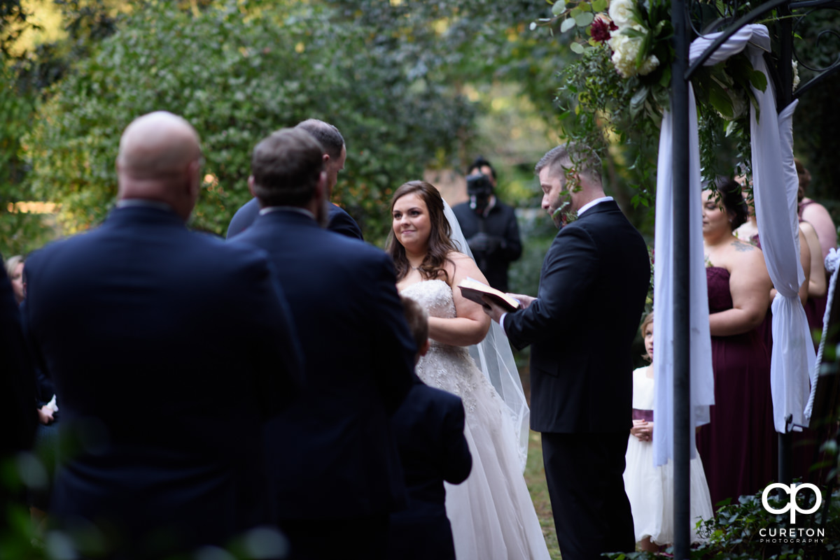Bride smiling at her groom during the wedding ceremony at Duncan Estate in Spartanburg,SC.