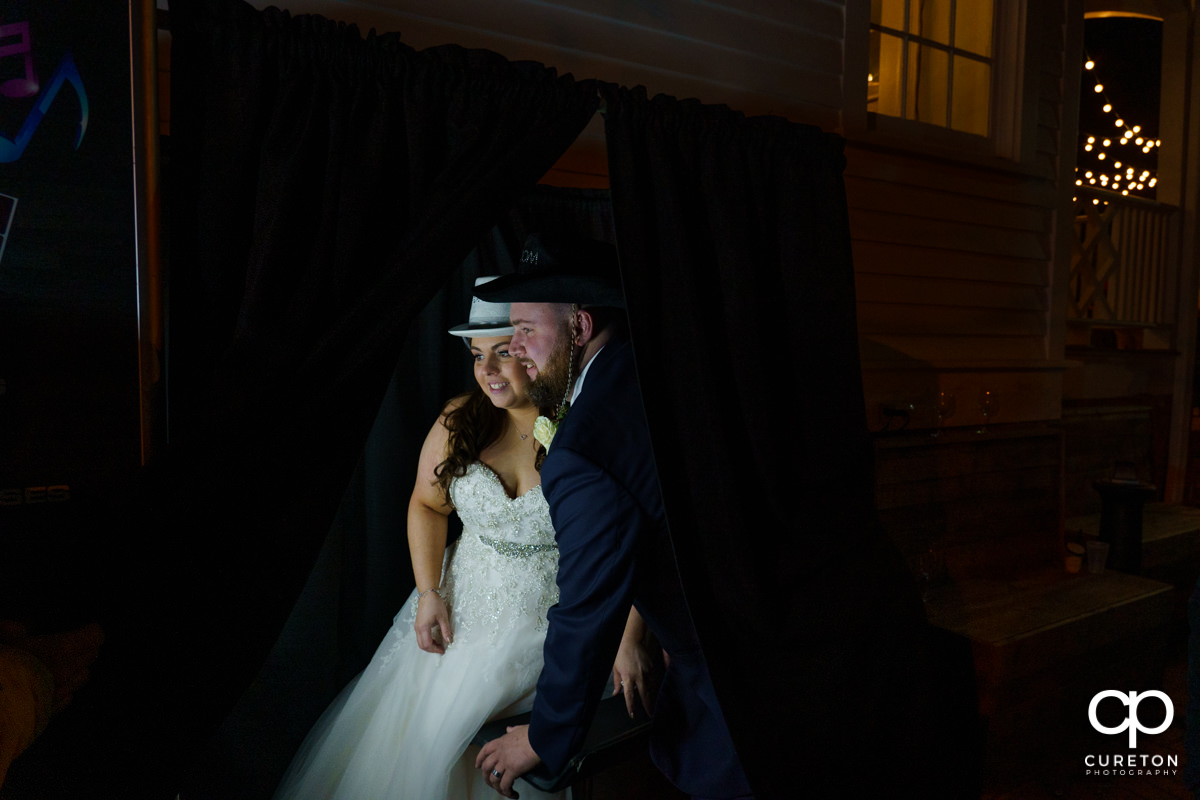 Groom and bride sharing a moment in the photo booth.