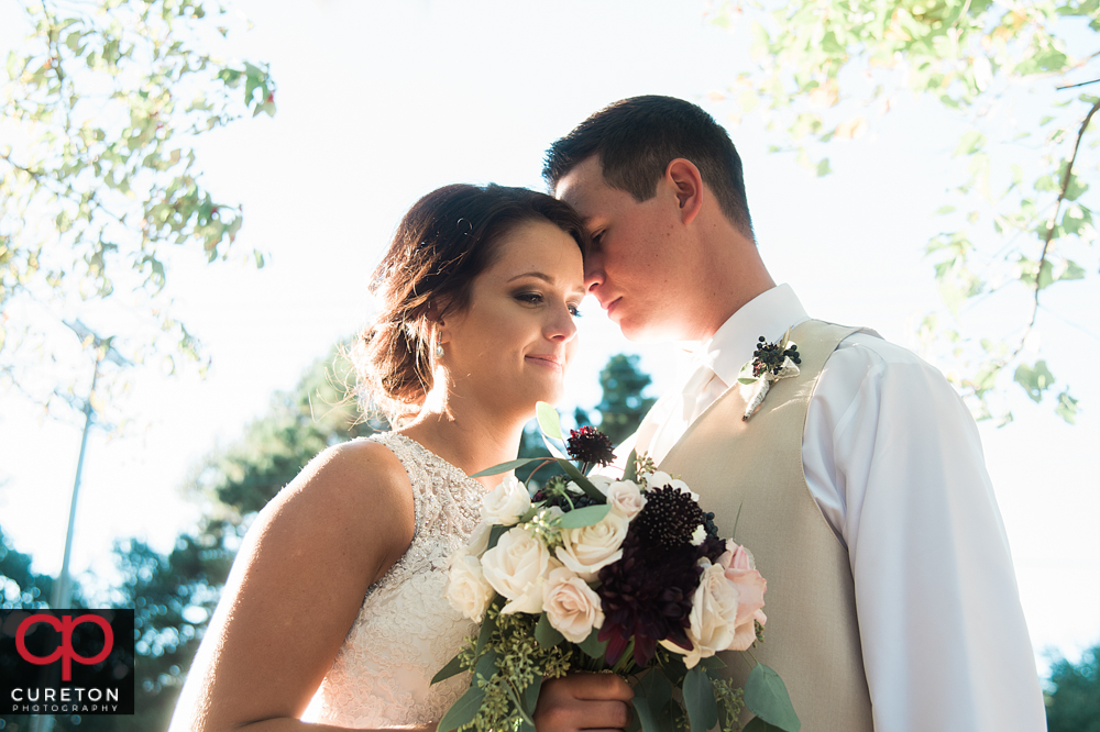 Bride and groom posing after their wedding in Easley.