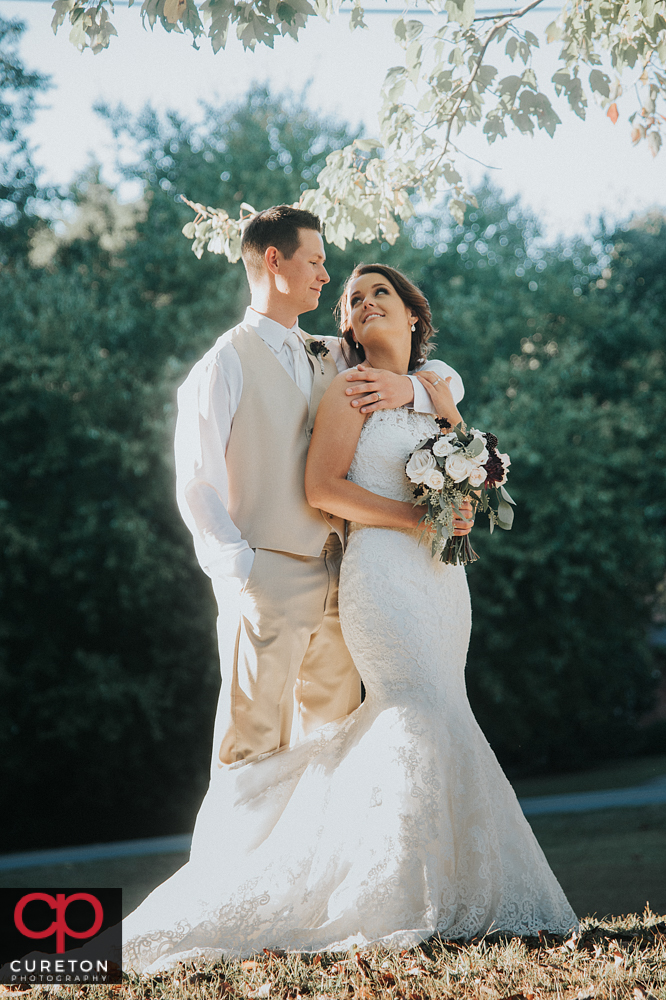 Bride and groom posing after their wedding in Easley.