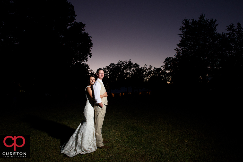 Bride and groom under a purple sky.