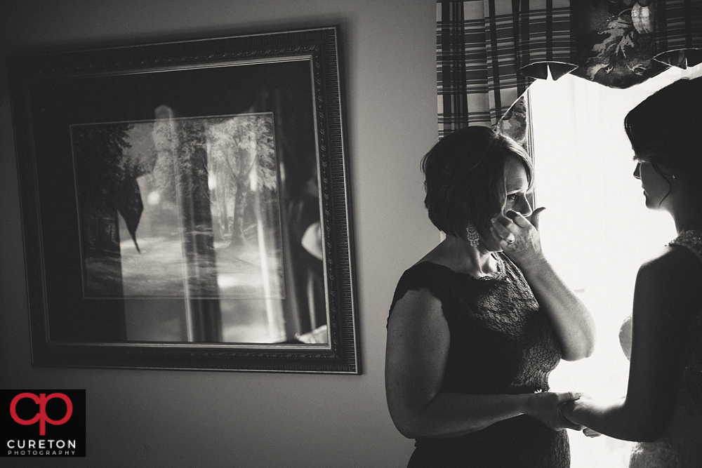 Bride's mom wiping away a tear.