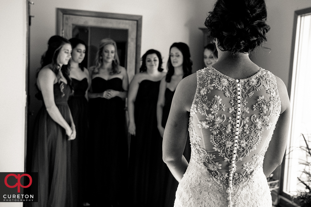 Bride revealing herself to the bridesmaids for the first time.