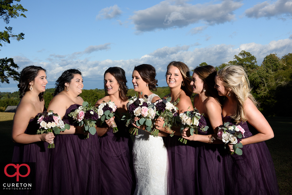 Bride and bridesmaids laughing.