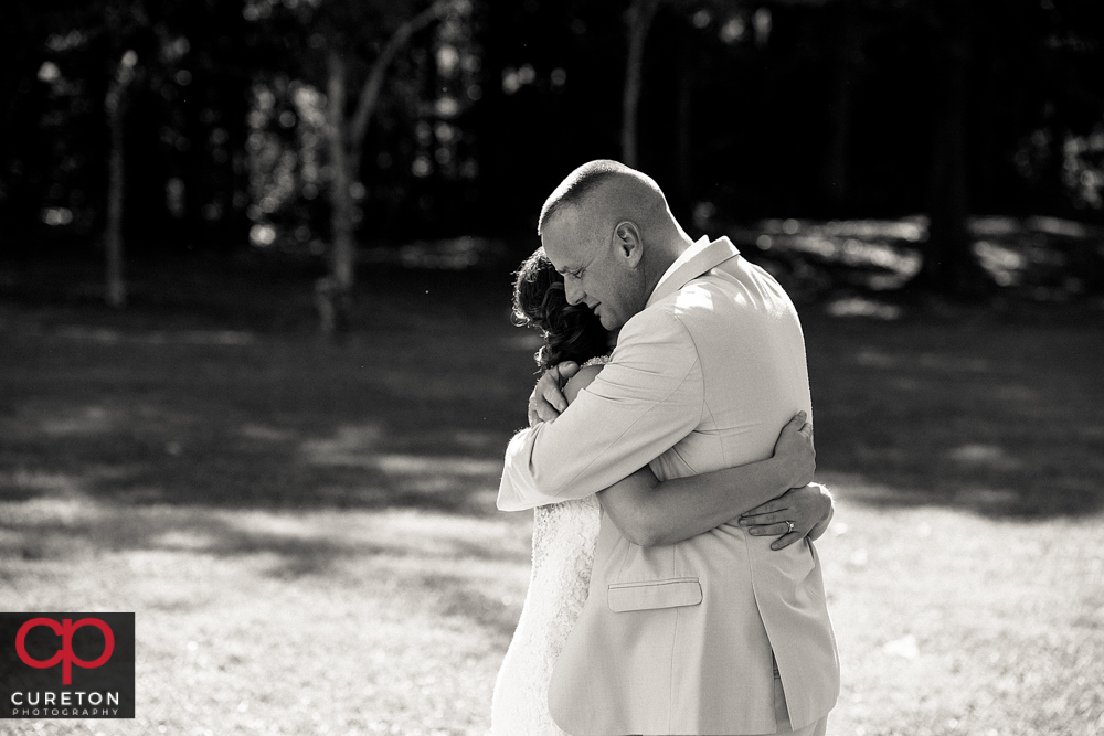 Bride and her father hugging.