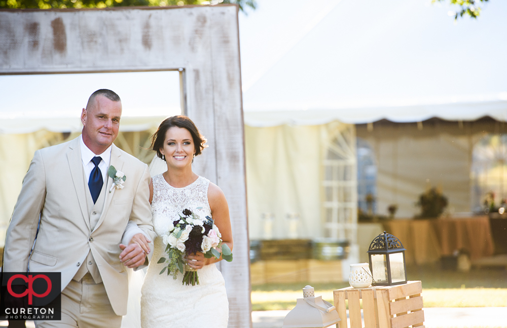 Bride and her father walking down the aisle.