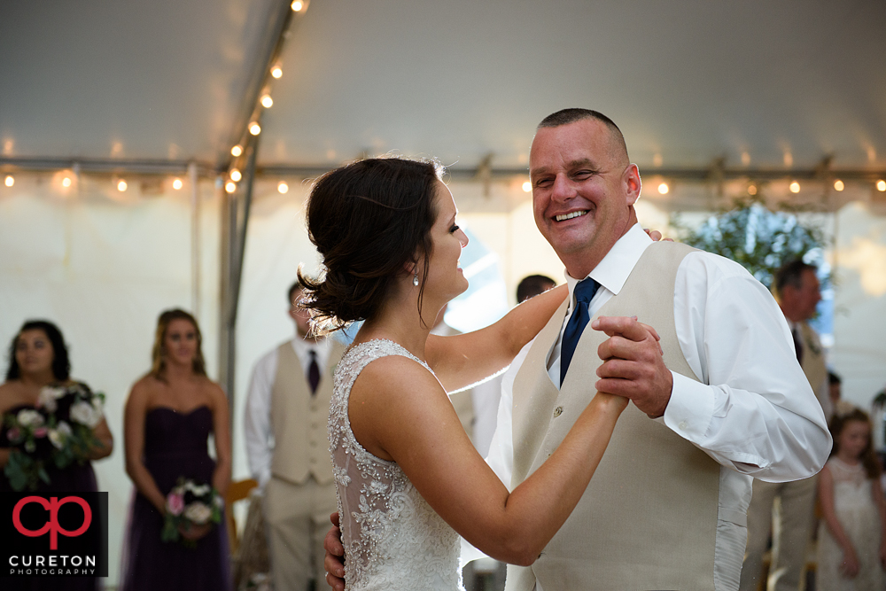 Bride and her father share a dance at her wedding reception.