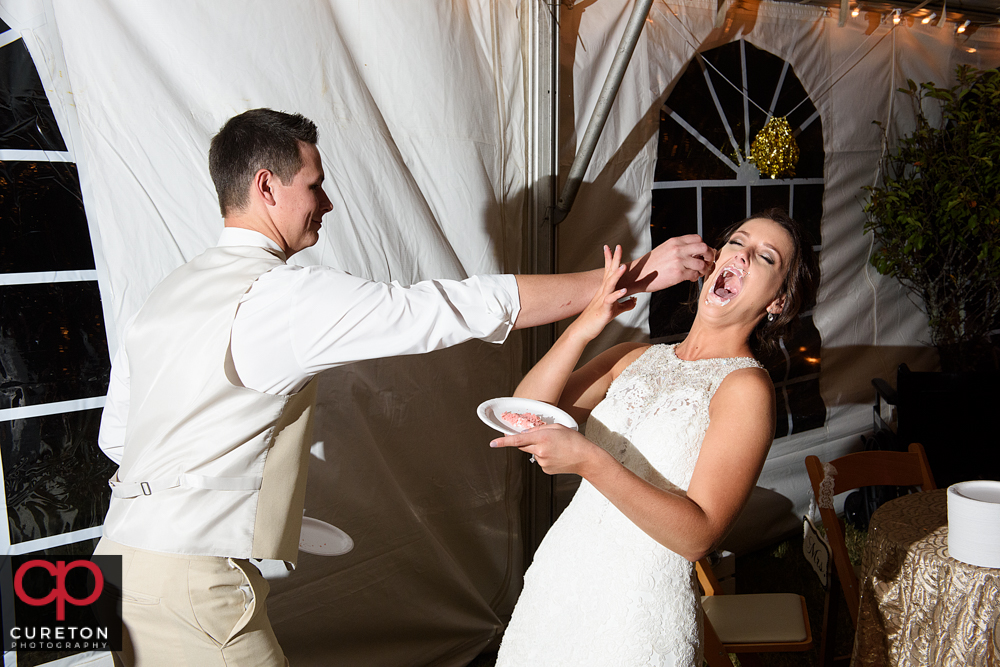 Bride and groom cutting the cake.