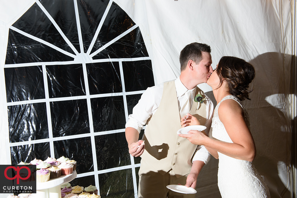 Bride and groom kissing.