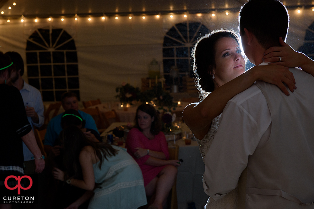 Bride staring at the groom during their last dance at the reception.