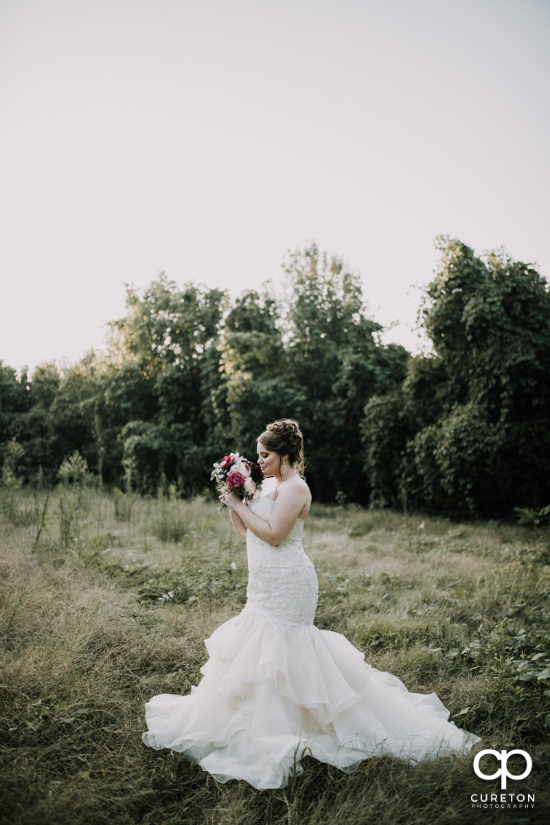 Bride in an overgrown meadow.